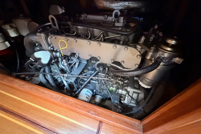 Slide: The Image of Engine compartment of a 2002 Hunter 460 sailboat, showcasing detailed mechanical components. - 76