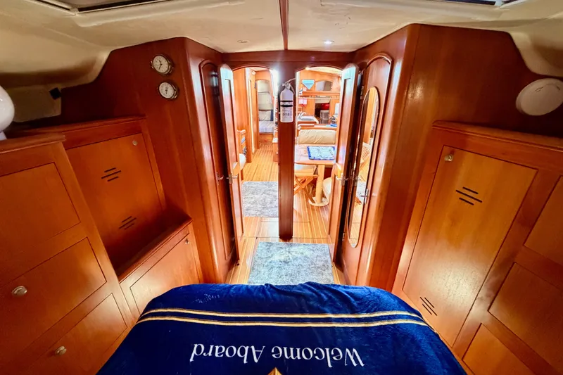 Slide: The Image of Luxurious interior of 2002 Hunter 460 yacht with wooden cabinetry and cozy bedding. - 72
