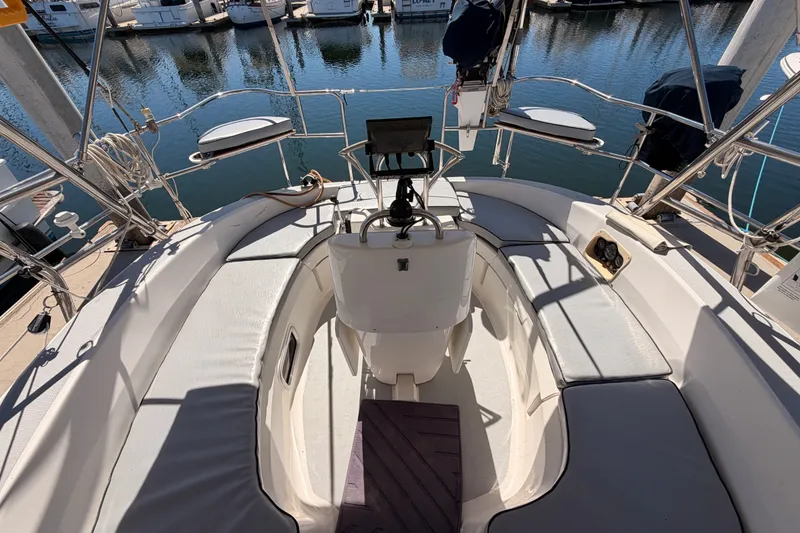 Slide: The Image of Cockpit of 2002 Hunter 460 sailboat with seating and navigation equipment, docked at marina. - 23