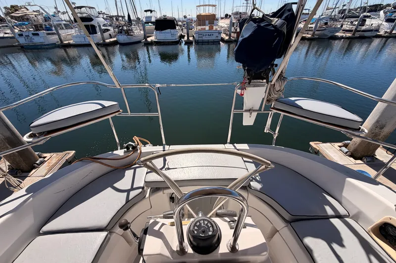 Slide: The Image of Cockpit view of a 2002 Hunter 460 sailboat docked at a marina. - 24