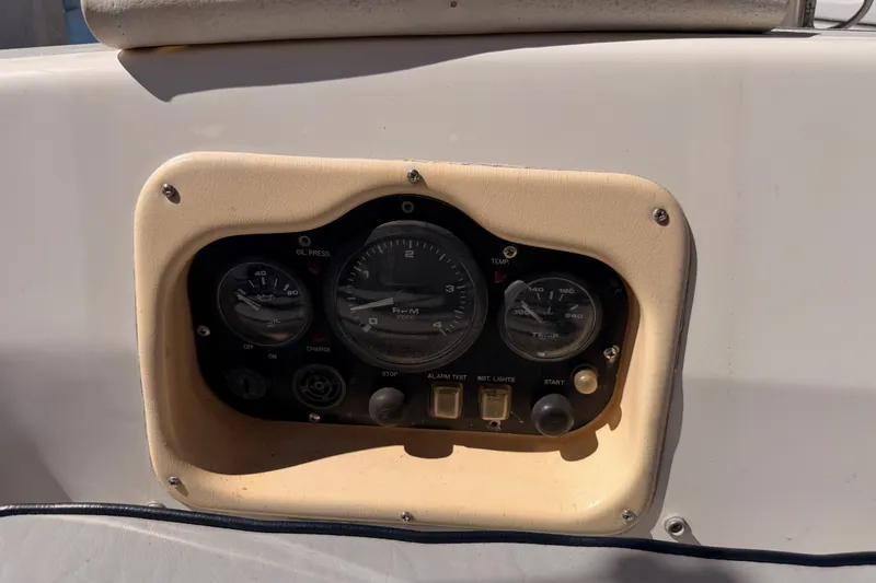 Slide: The Image of Control panel of a 2002 Hunter 460 boat with gauges and switches. - 32