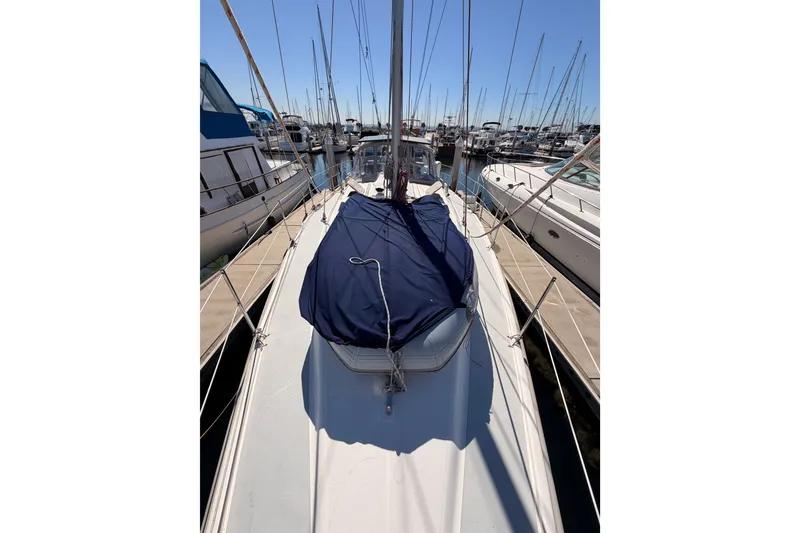 Slide: The Image of Sailboat Hunter 460, 2002 model, docked at marina with covered deck. - 14