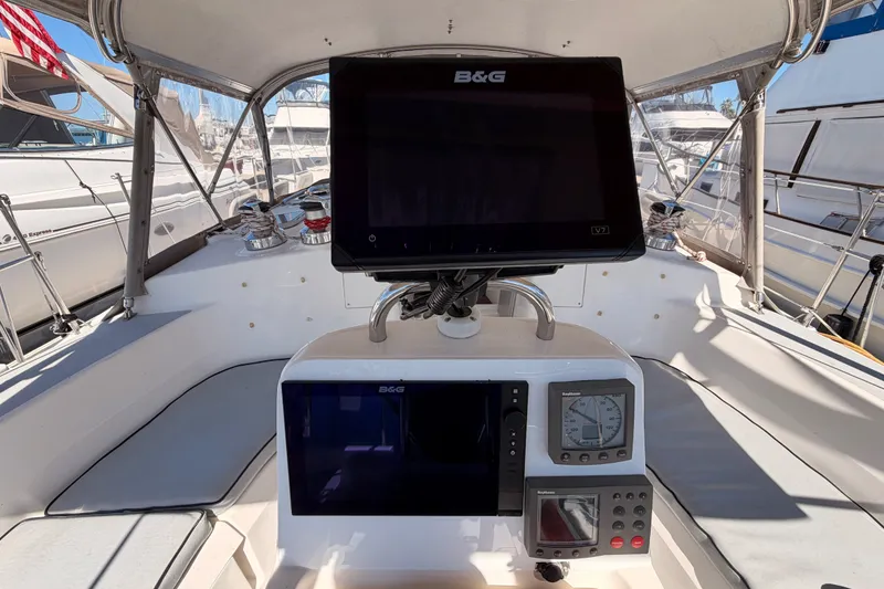 Slide: The Image of Cockpit of 2002 Hunter 460 sailboat with navigation equipment and seating. - 30