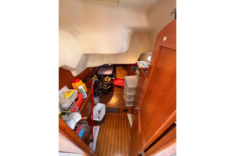 Slide: The Image of Storage area inside a 2002 Hunter 460 sailboat, featuring organized shelves and equipment. - 44