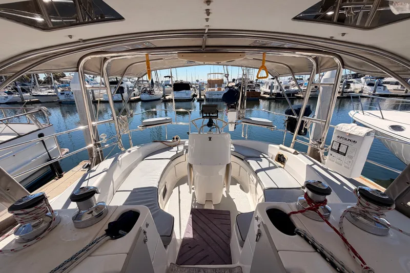 Slide: The Image of Cockpit view of a 2002 Hunter 460 sailboat docked at a marina. - 22