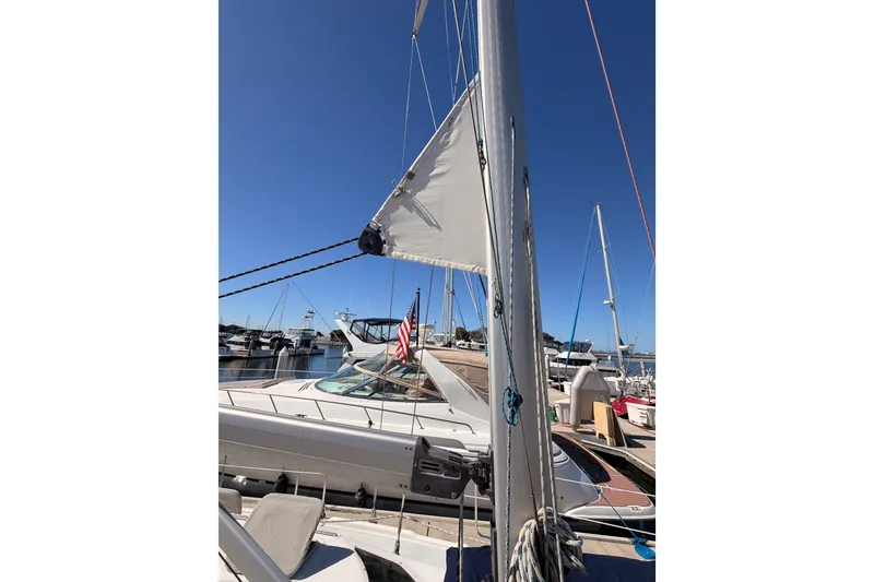 Slide: The Image of 2002 Hunter 460 sailboat docked at marina under clear blue sky. - 17