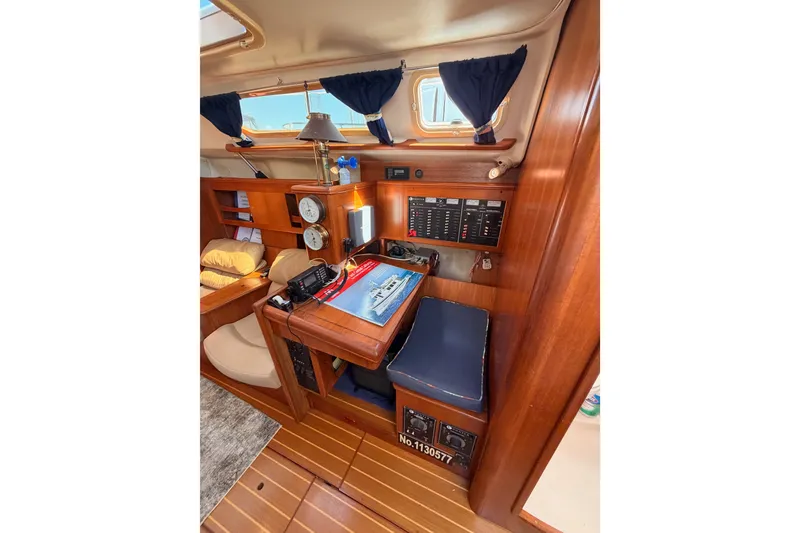 Slide: The Image of Interior of 2002 Hunter 460 sailboat with navigation station and wooden cabinetry. - 57