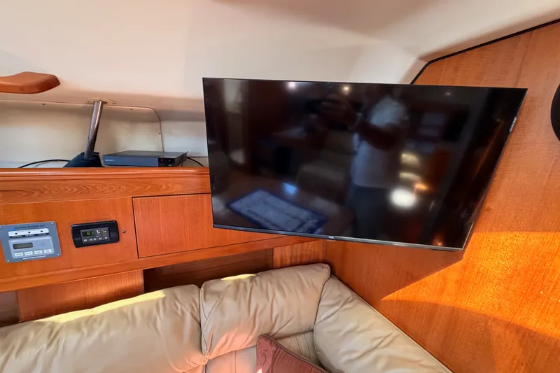 Slide: The Image of Interior of 2002 Hunter 460 yacht with mounted TV and control panel. - 64