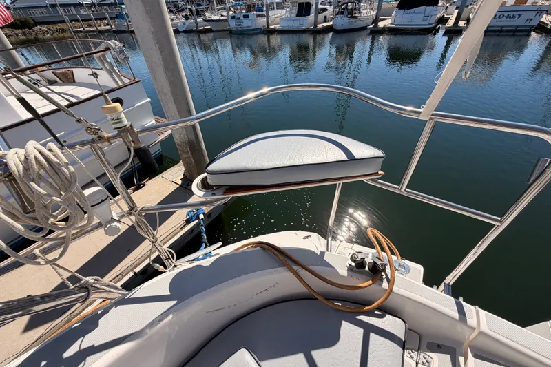 Slide: The Image of Deck view of a 2002 Hunter 460 sailboat docked at a marina. - 25