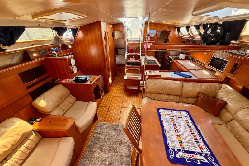 Slide: The Image of Luxurious interior of a 2002 Hunter 460 yacht with wood finishes and comfortable seating. - 75