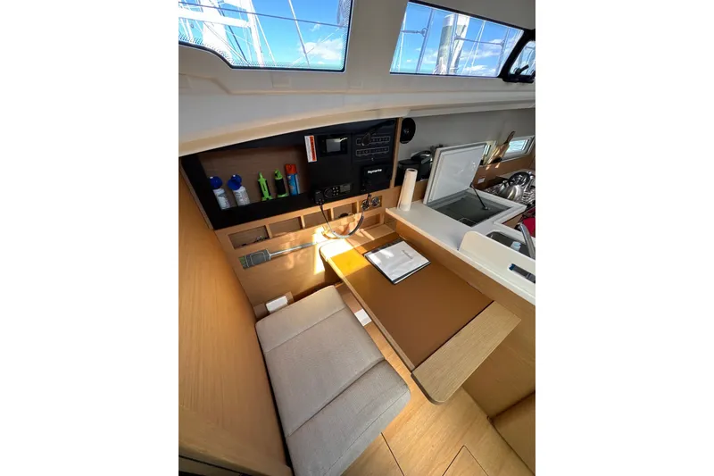 Slide: The Image of Interior of 2022 Jeanneau Sun Odyssey 410 sailboat, featuring a compact navigation station. - 13