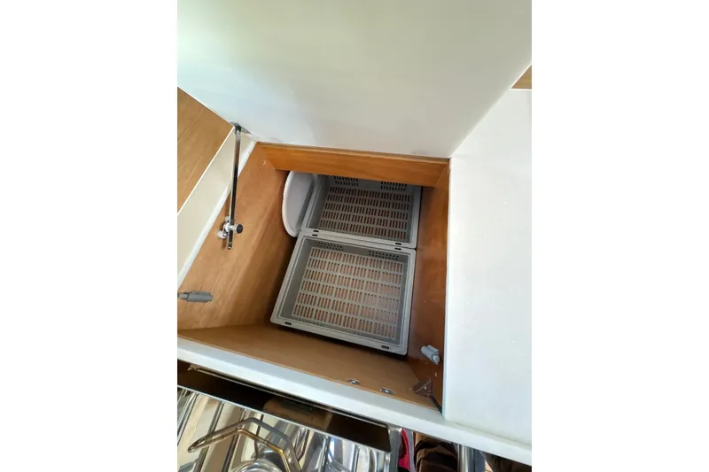 Slide: The Image of Interior storage compartment on 2022 Jeanneau Sun Odyssey 410 sailboat. - 16