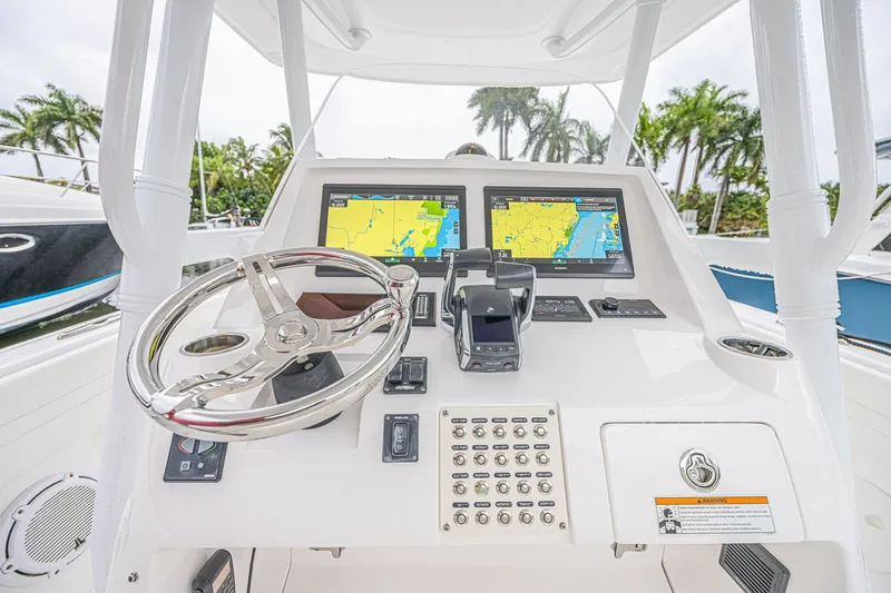 Slide: The Image of 2023 Intrepid 327 Nomad helm with dual navigation screens and sleek steering wheel. - 12