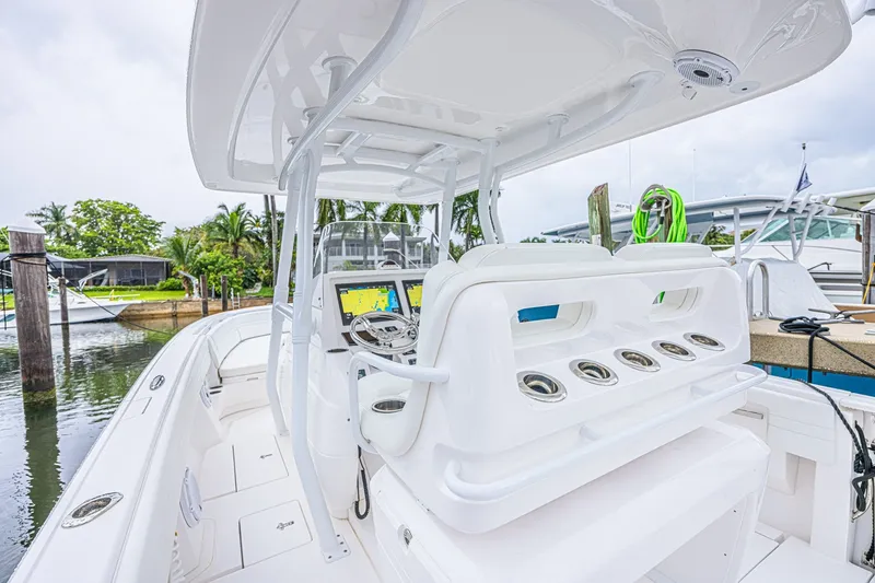 Slide: The Image of 2023 Intrepid 327 Nomad boat interior with helm, seating, and navigation equipment. - 6