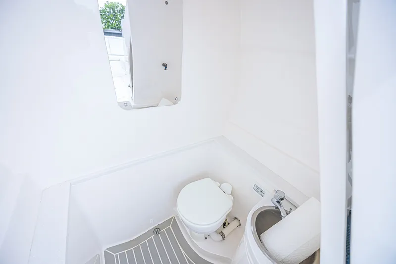 Slide: The Image of 2023 Intrepid 327 Nomad boat bathroom with toilet and sink. - 31