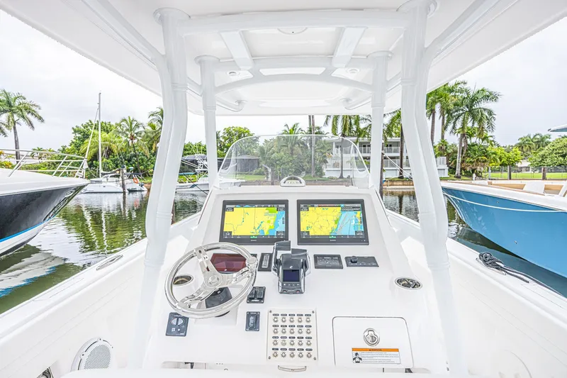 Slide: The Image of Cockpit view of 2023 Intrepid 327 Nomad boat with advanced navigation systems. - 9