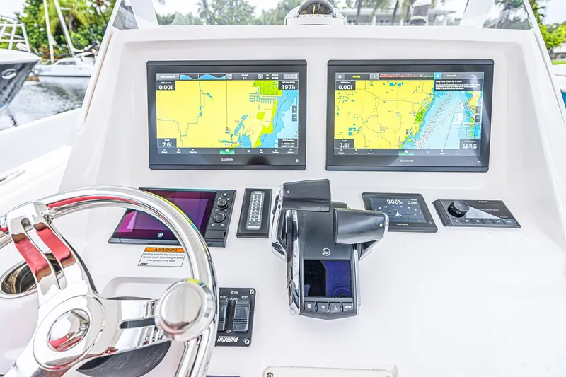 Slide: The Image of Control panel of 2023 Intrepid 327 Nomad boat with dual Garmin navigation screens. - 14