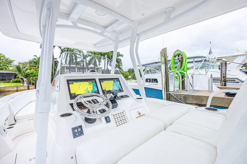 Slide: The Image of 2023 Intrepid 327 Nomad boat cockpit with advanced navigation displays and luxurious seating. - 15
