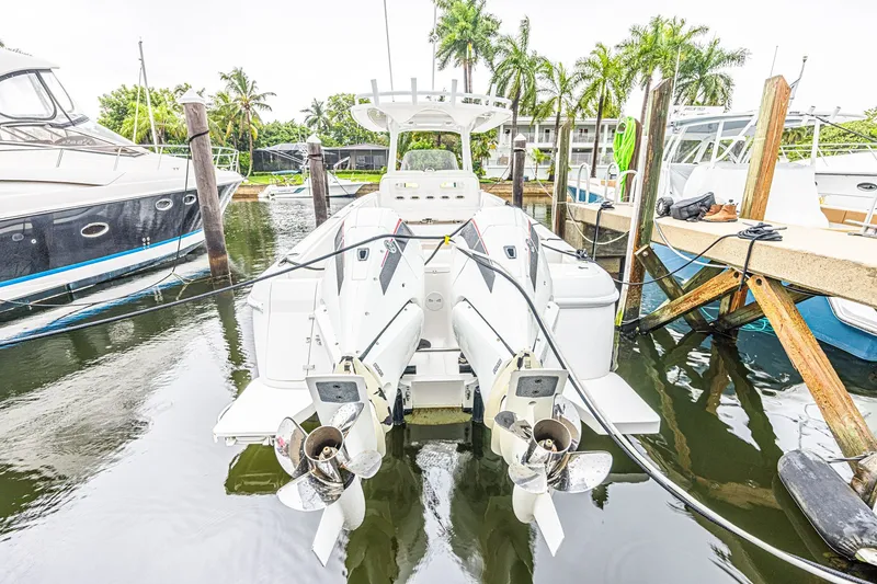 Slide: The Image of 2023 Intrepid 327 Nomad docked, showcasing dual outboard engines and sleek design. - 4