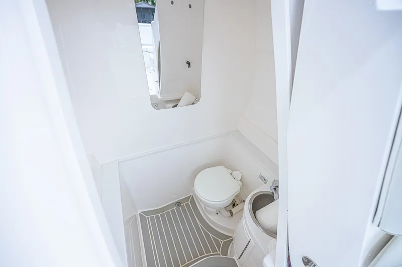 Slide: The Image of 2023 Intrepid 327 Nomad boat bathroom with toilet and sink. - 32
