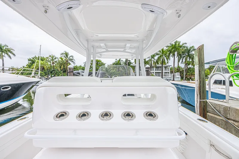 Slide: The Image of 2023 Intrepid 327 Nomad boat interior with sleek white seating and modern design. - 23