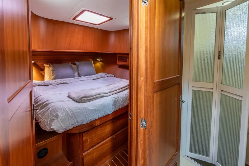 Slide: The Image of Cozy bedroom in 2010 North Pacific 39 Pilothouse yacht with wooden interior. - 16