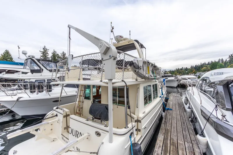 Slide: The Image of 2010 North Pacific 39 Pilothouse yacht docked at marina, surrounded by other boats. - 31