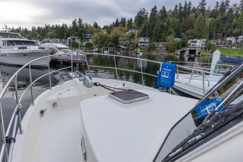 Slide: The Image of North Pacific 39 Pilothouse 2010 yacht docked in scenic marina with lush greenery. - 41