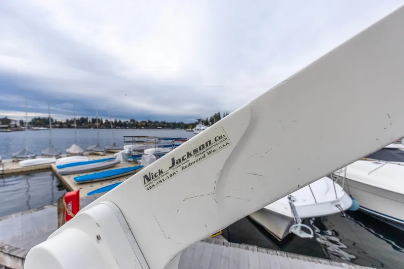 Slide: The Image of Close-up of a Nick Jackson Co. boat accessory at a marina, featuring a North Pacific 39 Pilothouse. - 34