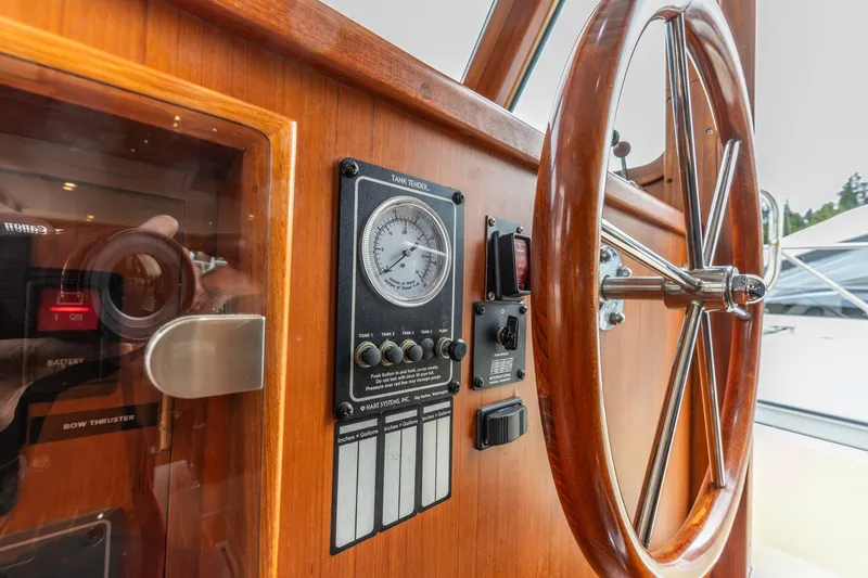 Slide: The Image of Wooden helm and control panel of 2010 North Pacific 39 Pilothouse yacht. - 23