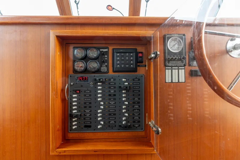 Slide: The Image of Electrical panel of a 2010 North Pacific 39 Pilothouse boat with gauges and controls. - 22