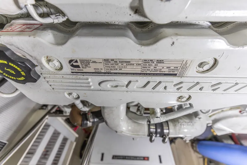 Slide: The Image of Engine compartment of a 2010 North Pacific 39 Pilothouse, featuring Cummins engine details. - 46
