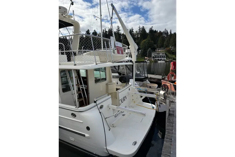 Slide: The Image of 2010 North Pacific 39 Pilothouse yacht docked at marina with scenic background. - 48