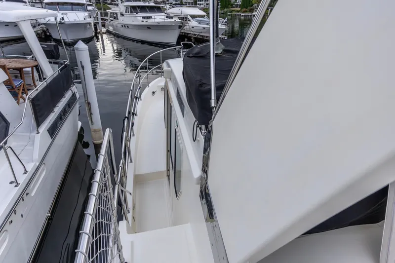 Slide: The Image of 2010 North Pacific 39 Pilothouse yacht docked among other boats. - 40