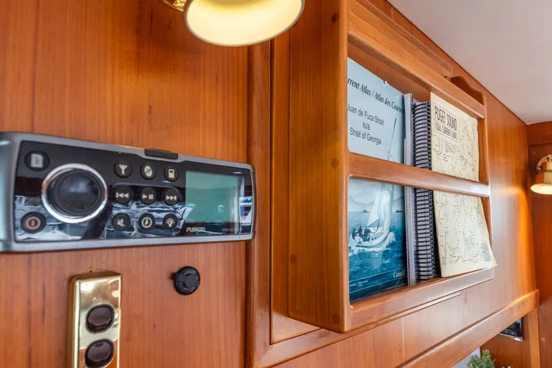 Slide: The Image of Interior of 2010 North Pacific 39 Pilothouse with navigation charts and stereo system. - 14