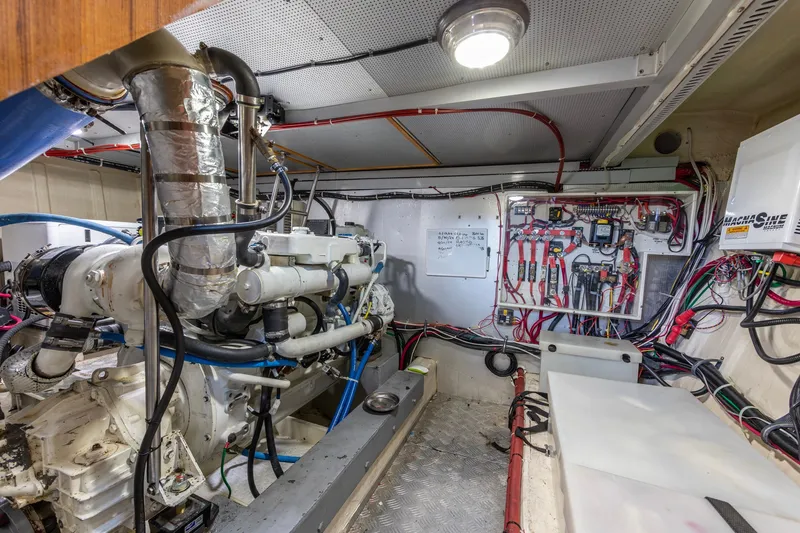 Slide: The Image of Engine room of 2010 North Pacific 39 Pilothouse with complex wiring and machinery. - 43