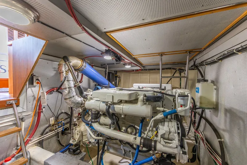Slide: The Image of Engine room of a 2010 North Pacific 39 Pilothouse, showcasing mechanical components and wiring. - 45
