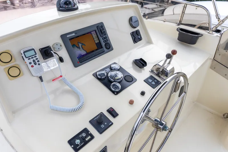 Slide: The Image of Pilothouse helm of 2010 North Pacific 39, featuring navigation equipment and steering wheel. - 36