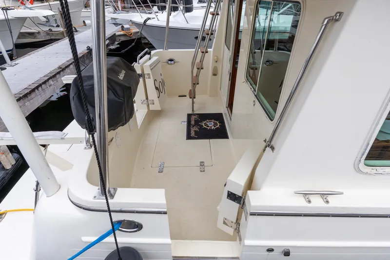 Slide: The Image of 2010 North Pacific 39 Pilothouse boat deck with dockside view and nautical decor. - 30