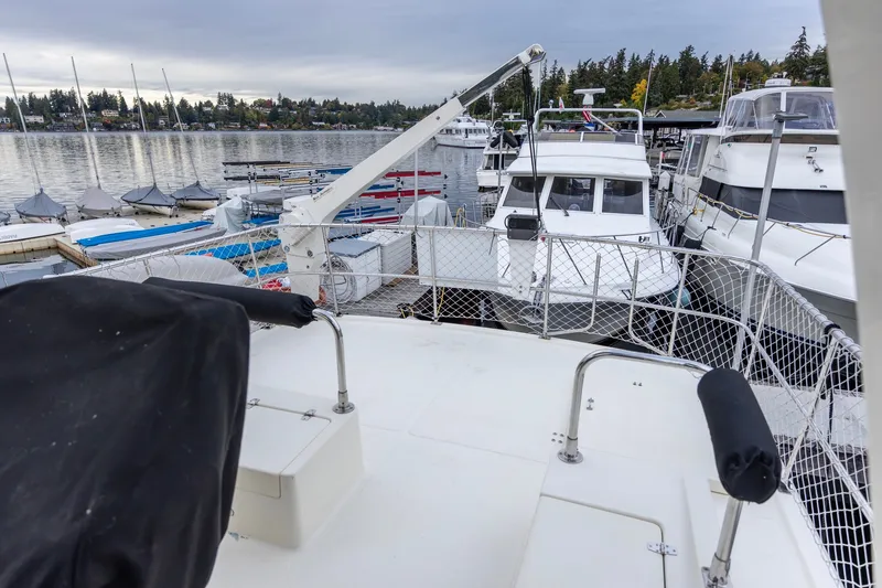 Slide: The Image of 2010 North Pacific 39 Pilothouse yacht docked at marina with scenic waterfront view. - 39