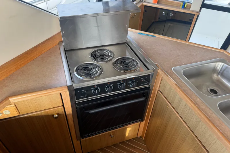 Slide: The Image of Kitchen area of 2000 Bayliner 3988 Command Bridge Motoryacht with stove and sink. - 15