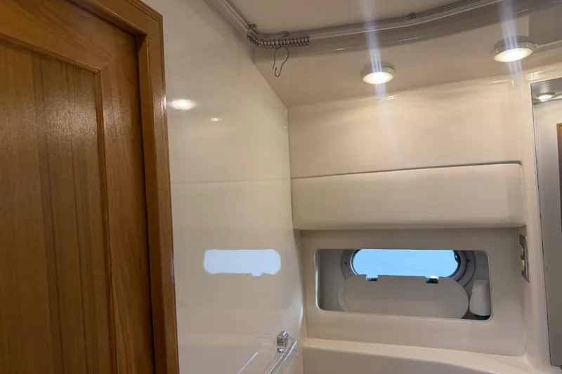 Slide: The Image of Interior of 2000 Bayliner 3988 Command Bridge Motoryacht, featuring sleek white walls and lighting. - 33