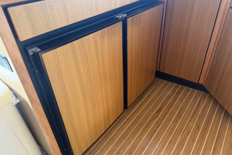 Slide: The Image of Wood-paneled refrigerator in 2000 Bayliner 3988 Command Bridge Motoryacht kitchen area. - 16
