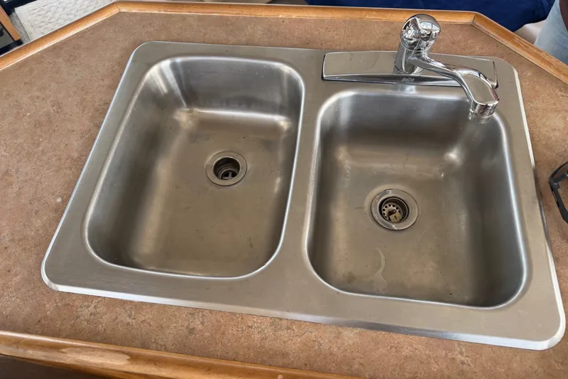 Slide: The Image of Stainless steel double sink with faucet on Bayliner 3988 Command Bridge Motoryacht, 2000 model. - 17