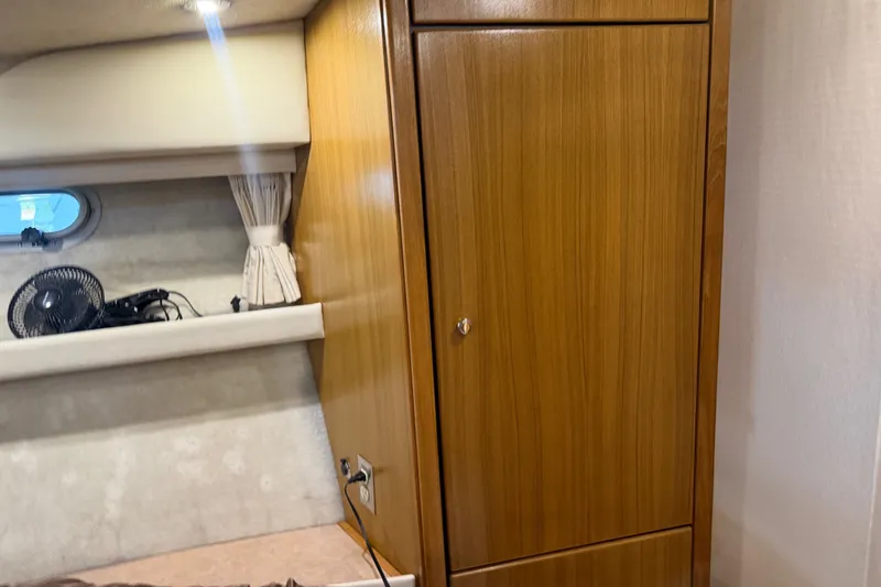 Slide: The Image of Interior of 2000 Bayliner 3988 Command Bridge Motoryacht with wooden cabinet and small window. - 23