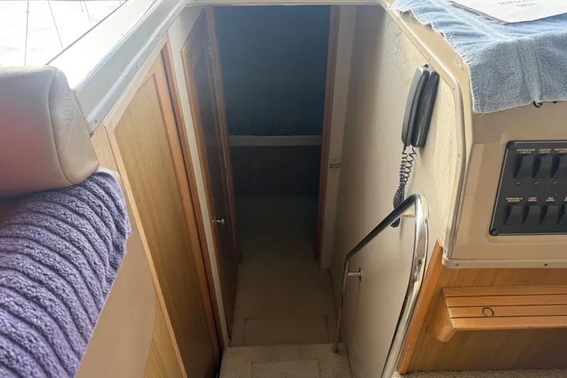 Slide: The Image of Interior view of a 2000 Bayliner 3988 Command Bridge Motoryacht, featuring a hallway and control panel. - 19