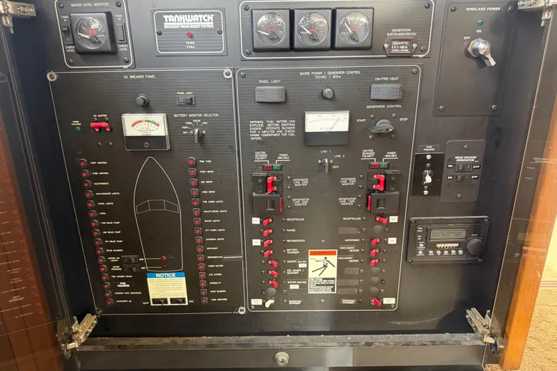 Slide: The Image of Control panel of a 2000 Bayliner 3988 Command Bridge Motoryacht, featuring gauges and switches. - 49