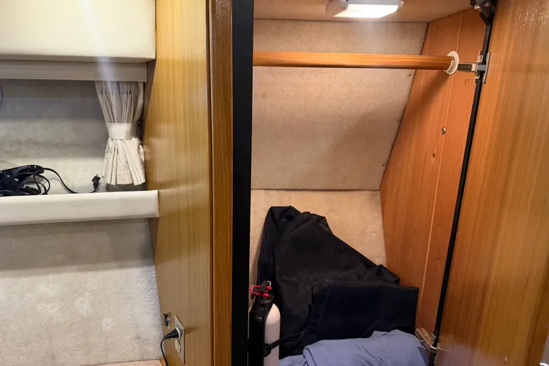 Slide: The Image of Interior closet of 2000 Bayliner 3988 Command Bridge Motoryacht with wooden finish and storage space. - 24