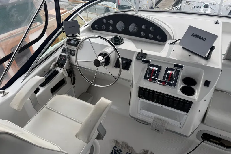 Slide: The Image of Cockpit of 2000 Bayliner 3988 Command Bridge Motoryacht with steering wheel and navigation equipment. - 35