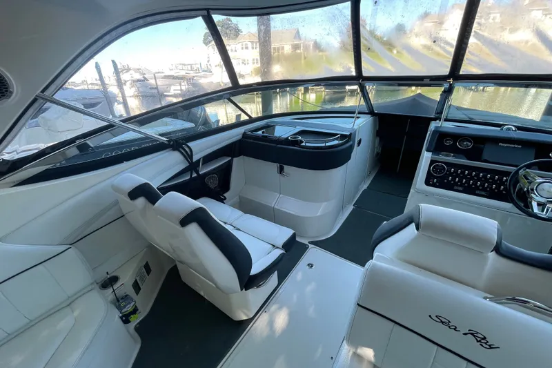 Slide: The Image of Interior of 2015 Sea Ray SLX 350 boat with white seating and modern dashboard. - 8